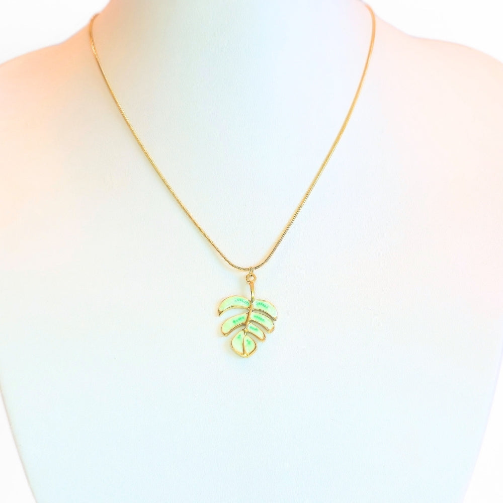 Necklace with a green leaf pendant on a mannequin with a white background